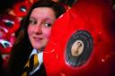 Twelve-year-old Maisie Harris with a poppy made from a vinyl record dedicated to her great-great-grandfather Archibald Harris.		Picture: OX71019 Damian Halliwell