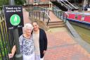 Jenny Ratcliff and Surinder Dhesi by the new cycle sign in Chamberlain Court..