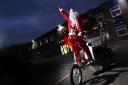 Oxford food bank has decorated their rick shaw once again, which they will be using during their Christmas lunch on xmas day. .Riding the rickshaw dressed as Santa is Sara Strong (volunteer)..30.11.2017.Picture by Ed Nix..