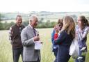 Beekeeper Tanya Hawkes presents Prince Charles with anti-wrinkle cream at FarmED watched by owners Ian and Celene Wilkinson and her daughter Esme. All pictures Ed Nix