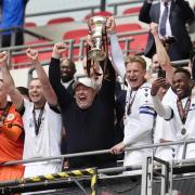 Bromley manager Andy Woodman lifts the play-off final trophy at Wembley