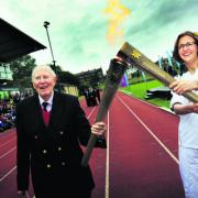 Sir Roger exchanges the Olympic flame with Nicola Byrom Picture OX52912 : Ed Nix