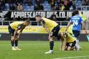 Oxford United players are dejected after the defeat against Peterborough United