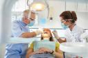 A stock image of a dentist working on a patient