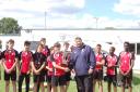 CHAMPIONS: Bartholomew School captain Jacob Moir is presented with the King Charles Cup by Oxford Cavaliers’ head of youth development Jamie Jones