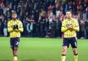 Kyle Edwards and Ciaron Brown applaud the Oxford United fans at the final whistle