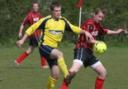 TUSSLE: Brize Norton's Steve Marshall (right) is beaten to the ball by Ducklington's Dan Walker during his side's 2-1 defeat in the Premier Division on Saturday