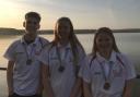Witney swimmers (from left) Reuben Coppuck, Lauren Mellings and Jess Miller with their medals