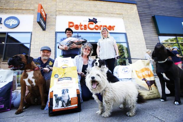 Witney Gazette: Bonnie Cowdrey (centre) with donations for the Chipping Norton Pet Food Bank, upon its launch in June 2020. Picture: Ed Nix