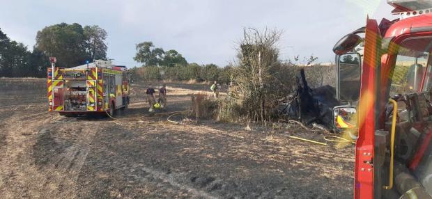 Witney Gazette: Firefighters at the scene of the field blaze in Paxford. Picture: Oxfordshire Fire and Rescue Service