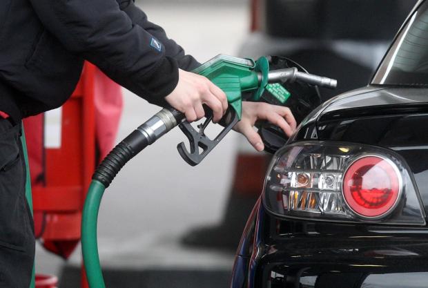 Witney Gazette: Someone using a fuel pump at a petrol station (PA)