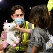 Handout photo issued by the Ministry of Defence (MoD) of military personnel handing out food, drink, toys, and blankets during Op PITTING at RAF Brize Norton to arrivals who have been evacuated from Afghanistan, via the UAE, under the Afghan Relocation