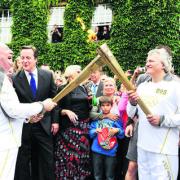 Cancer campaigner Clive Stone, left, transfers the flame to Roland Read, of Oxford
