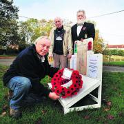 Keith Brooks, front, with two of Horspath’s three surviving veterans of the Second World War, John Sheppard, left, and John West, with his memorial                                                             Picture: OX70917 Jon Lewis