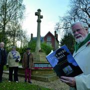By Wheatley war memorial is co-editor Bill Jackson with the book They Were a Wall: Wheatley in A World at War 1914-19, with others who contributed, from left, John Fox, Anne Ledwith and John Prest      Picture: OX71060 Simon Williams