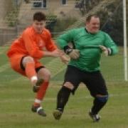 OUT MY WAY! Finstock's Luke Simmons is foiled by Wootton Sports goalkeeper Leigh Grant