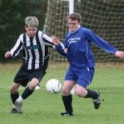 BATTLING IT OUT: FC Mills' Chris Lawrence puts Witney Royals' Richard Benham under pressure during his side's 7-1 defeat in Division 1
