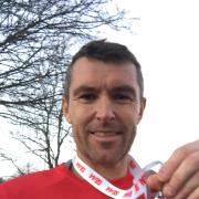Witney's Tegs Jones with his medal from the SEAA Inter County Cross Country Championships