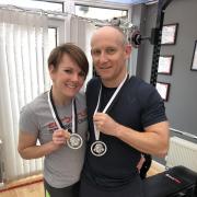 Lucy and Mark Anderson with their powerlifting medals
