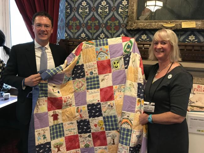 PROUD: Witney MP Robert Courts and Liz Duncan from Witney Refugee Action Group hold the quilt in Parliament 		Picture: Kai Tabacek
